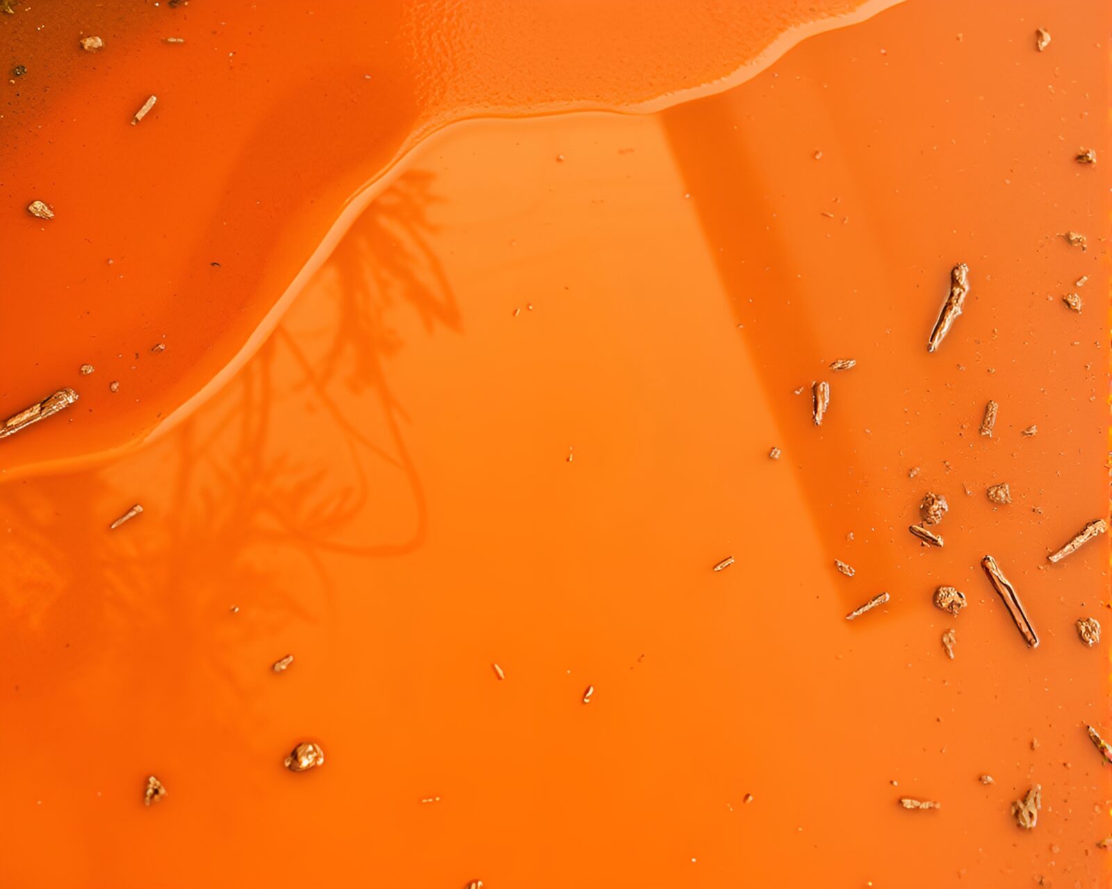 Burnt orange puddle reflects mystical ley lines in stencil art