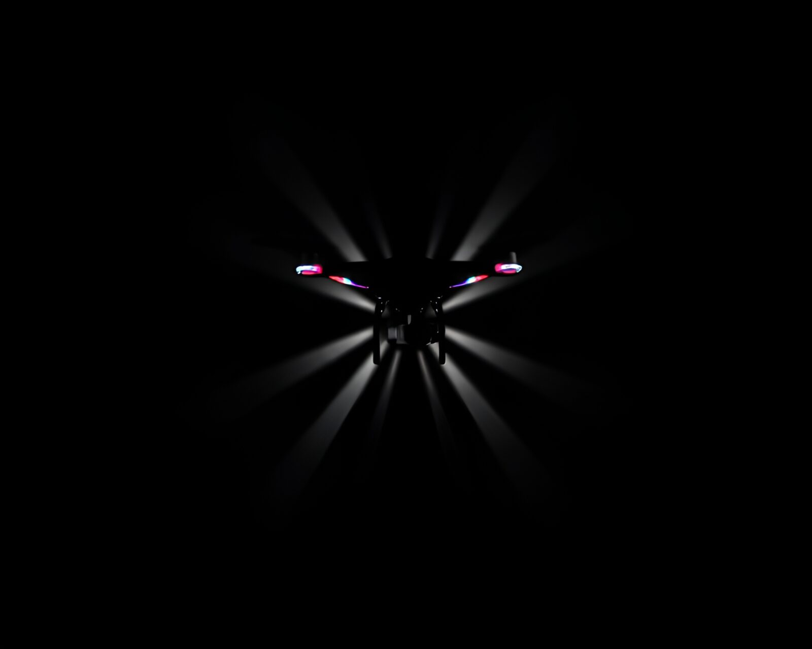 Black and white image of person controlling a vibrant drone