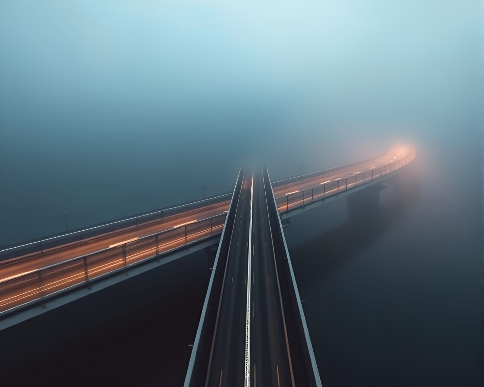 Minimalist fog-enveloped bridge crossing with dynamic motion blur