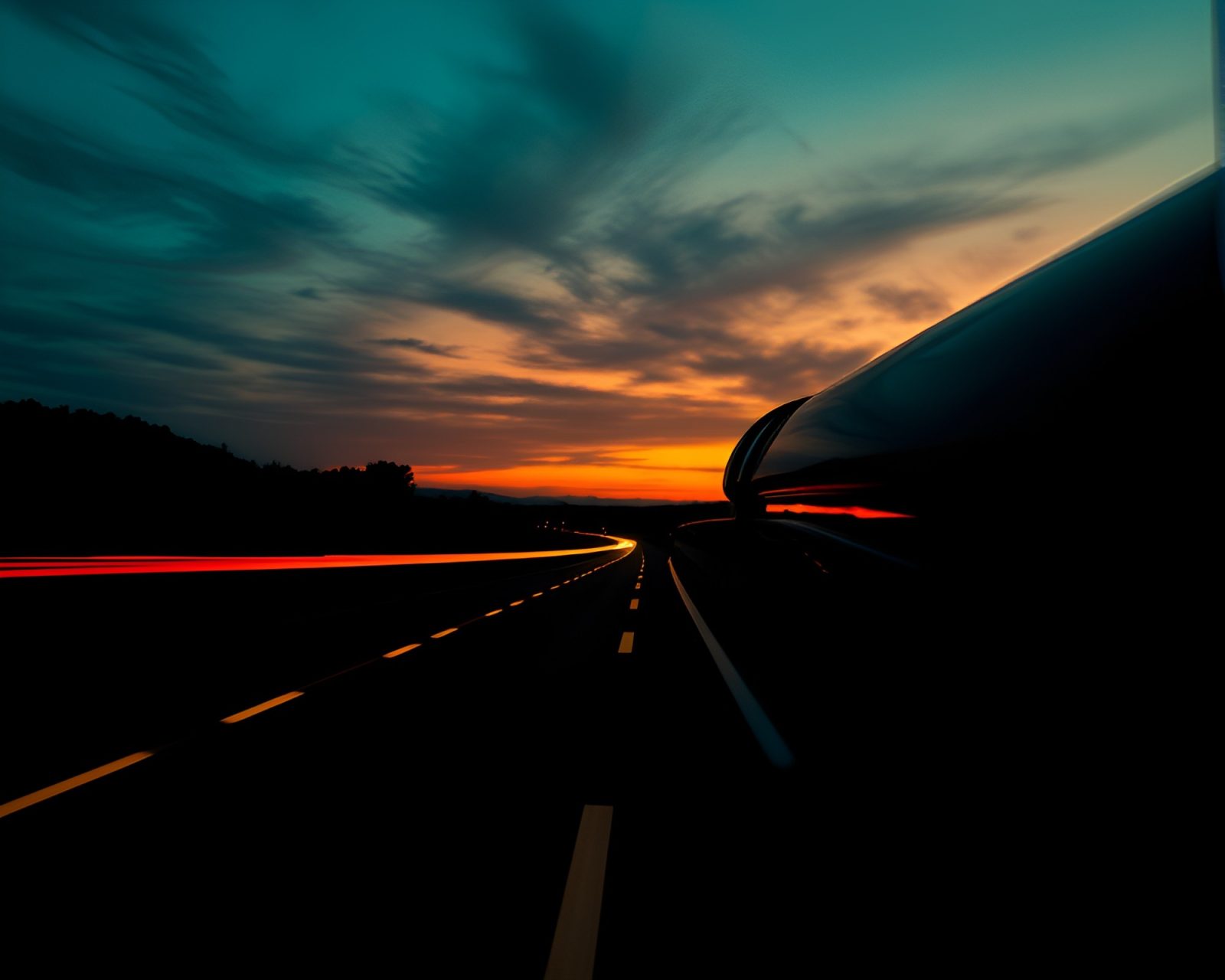 Long exposure photograph of car light trails at sunset