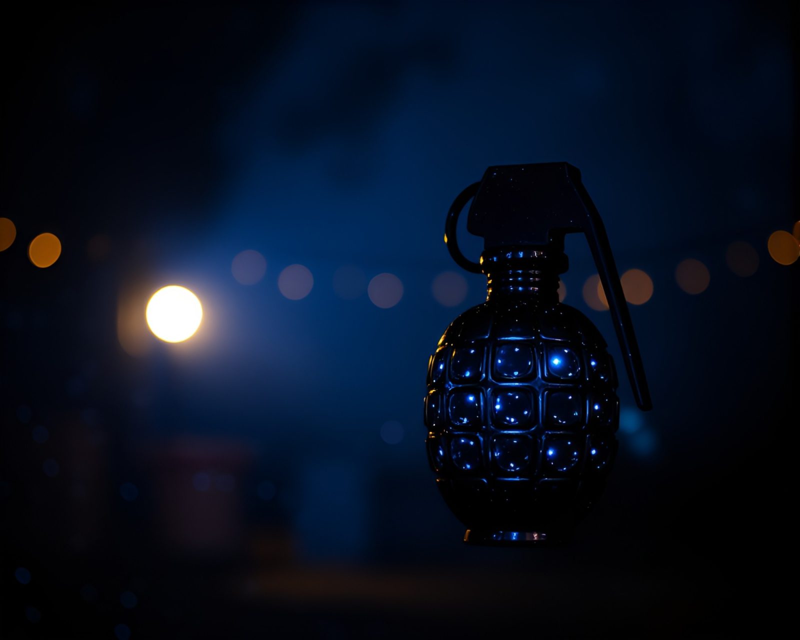 A glowing antimatter grenade emitting blue light in darkness