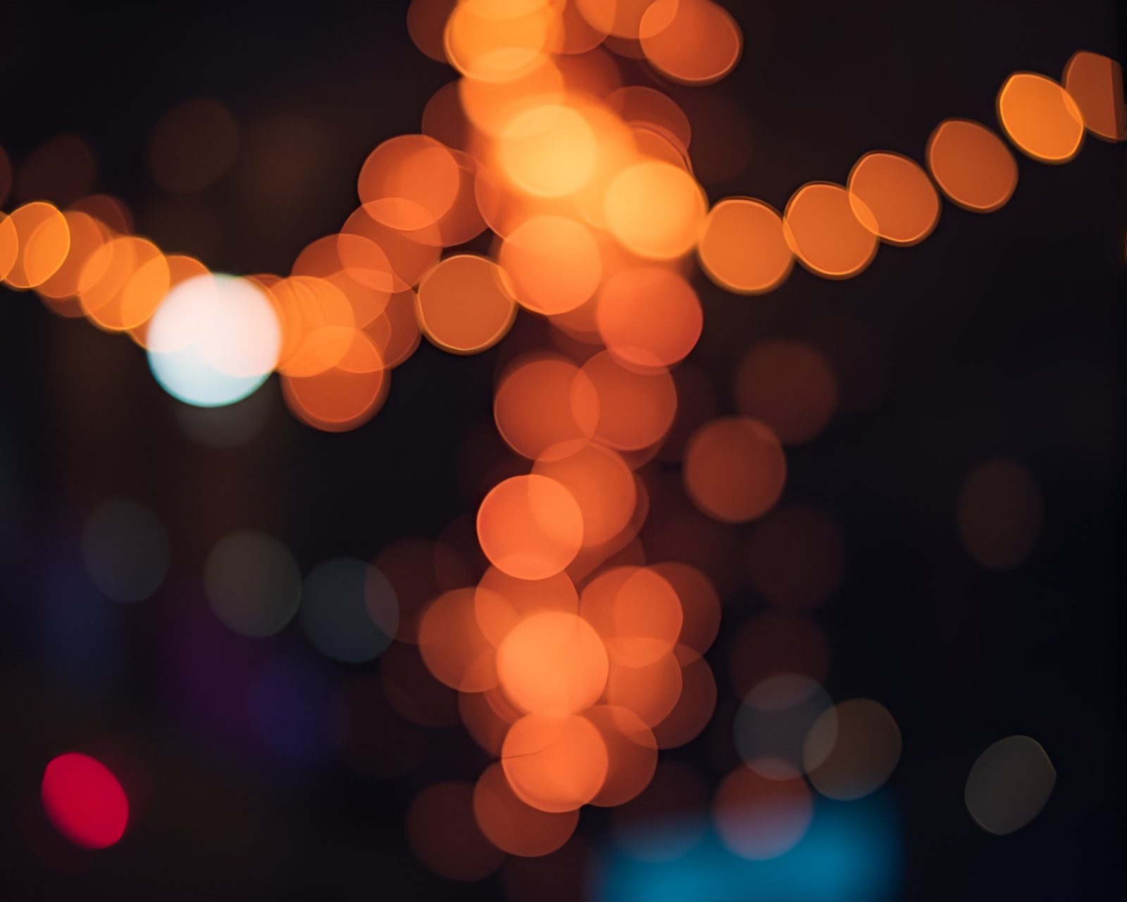 Colorful bokeh lights surrounding intricate tattoo flash art design