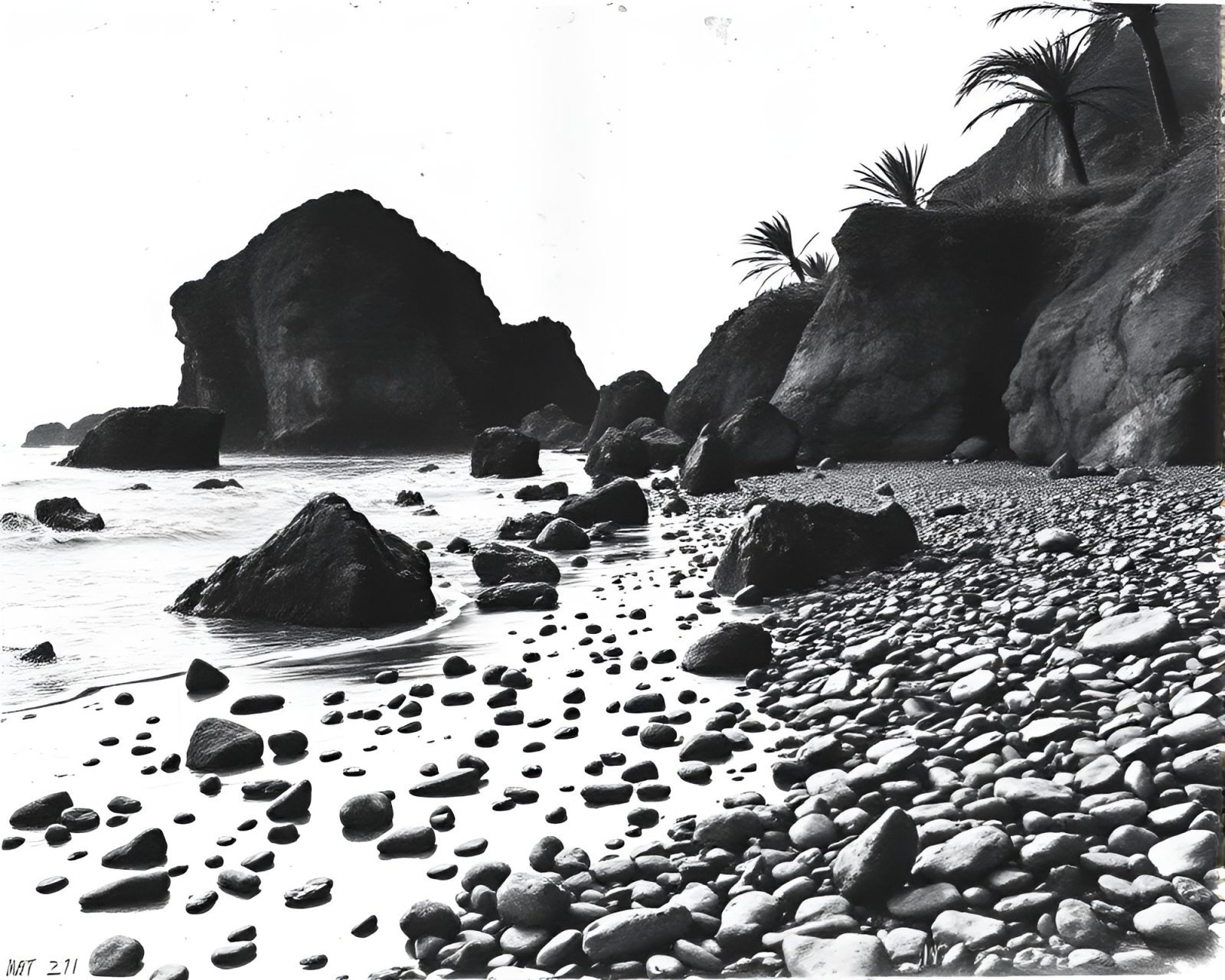 High-contrast noir image of pebble beach with ink wash drips