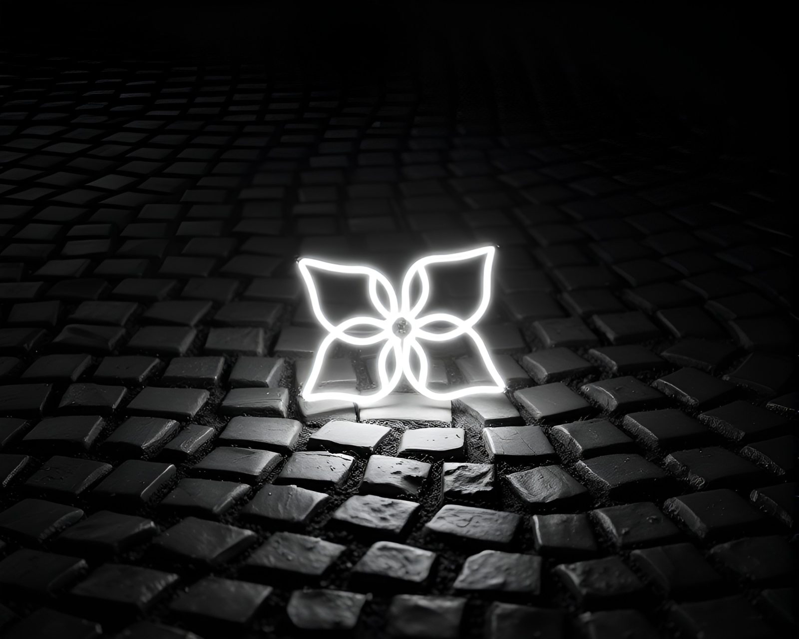 Black and white image of origami flower glowing in neon