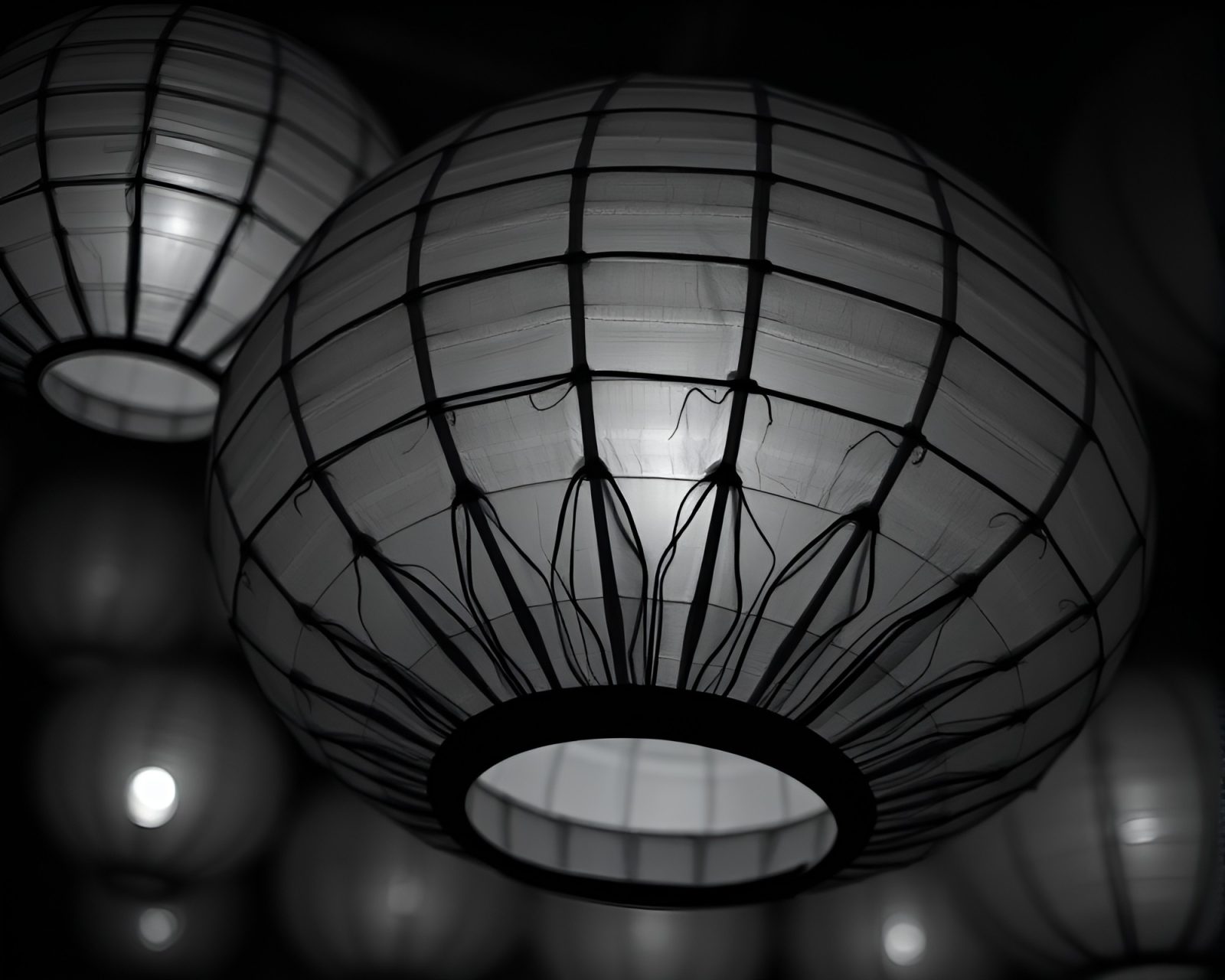 A desaturated paper lantern glowing in fabric folds