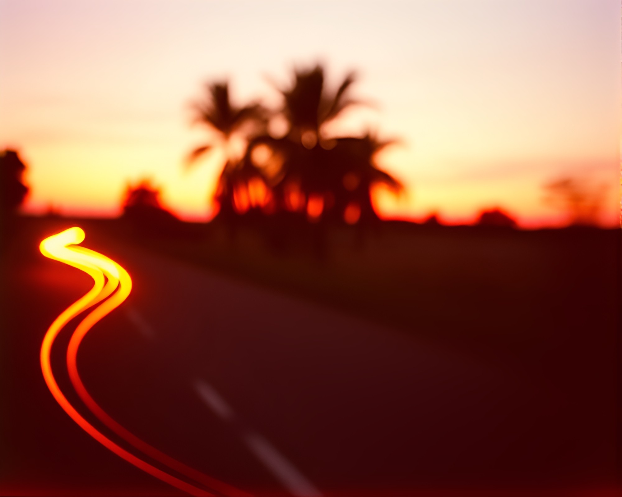 Rustic pottery illuminated by sunrise-pink car light trails – free AI stock image