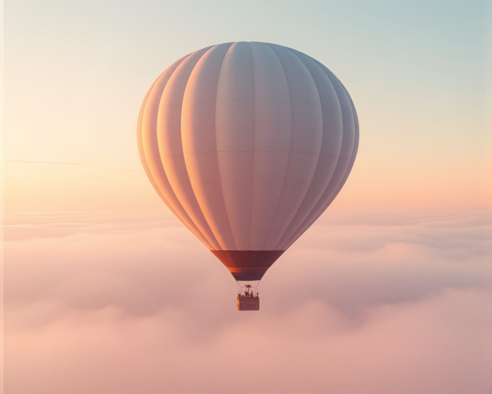 A serene hot air balloon drifting through a pastel-hued foggy sky