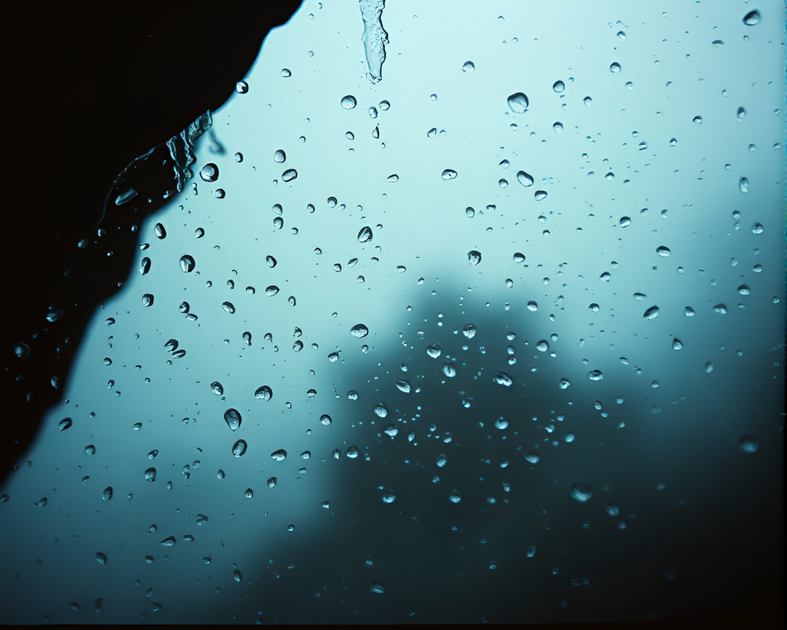 Gritty film-like water droplets in surreal dystopian setting