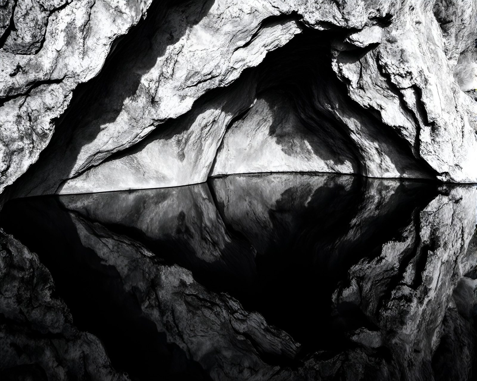 Black and white image of a double reflected glacial cave